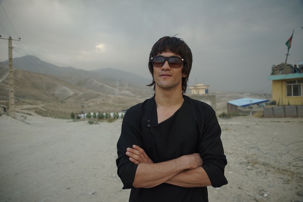 Abass Alizada , the Afghan Bruce Lee lookalike, is standing outdoors. Shot taken while fiming RTD documentary Dragon of Afghanistan.